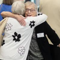 Two women at event hugging